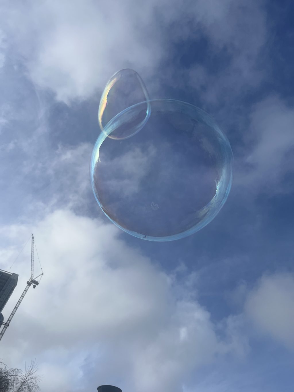 a large bubble floating in the blue sky