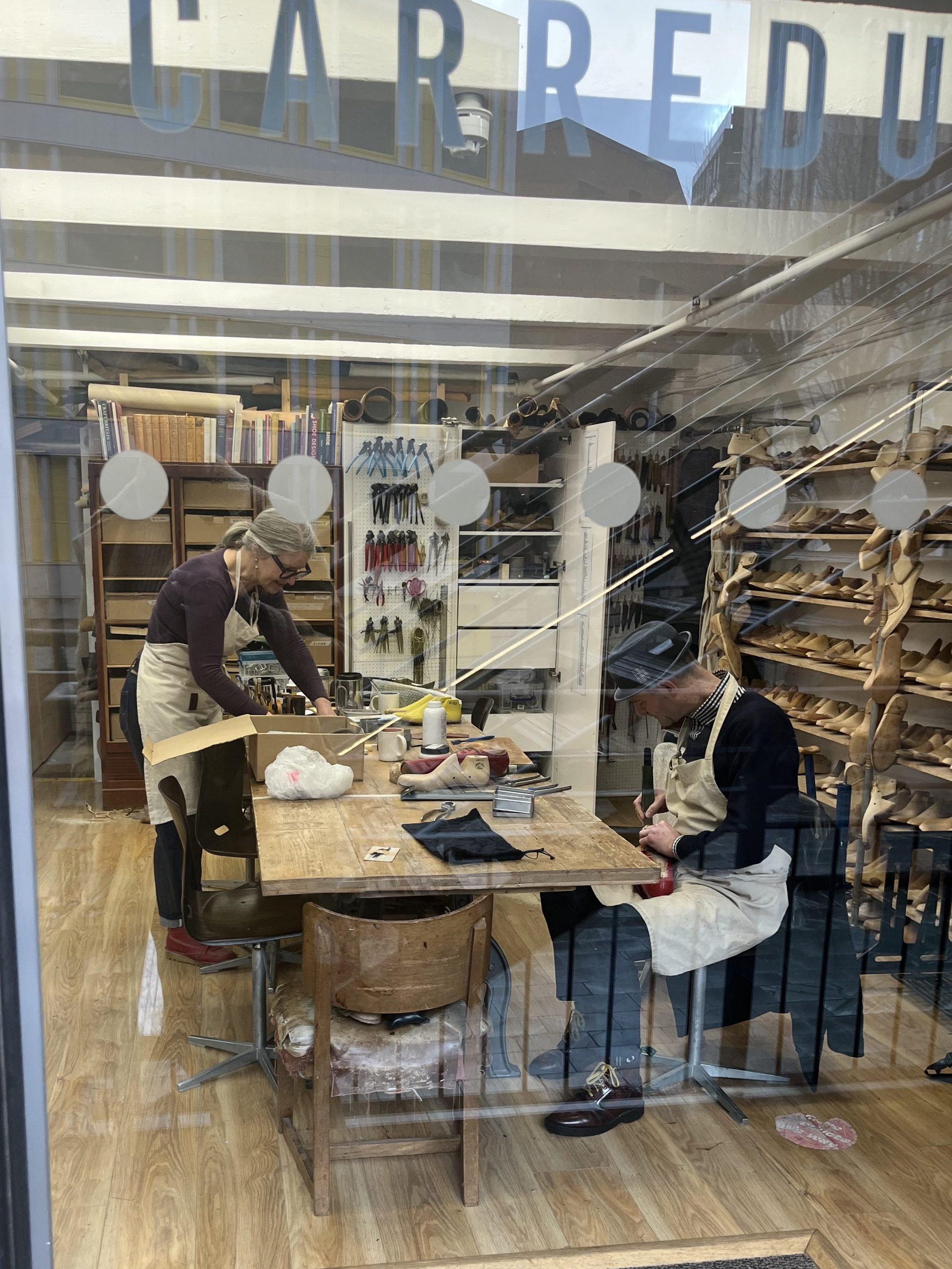 Artisan shoe makers working in their studio at the Oxo building, Southbank.