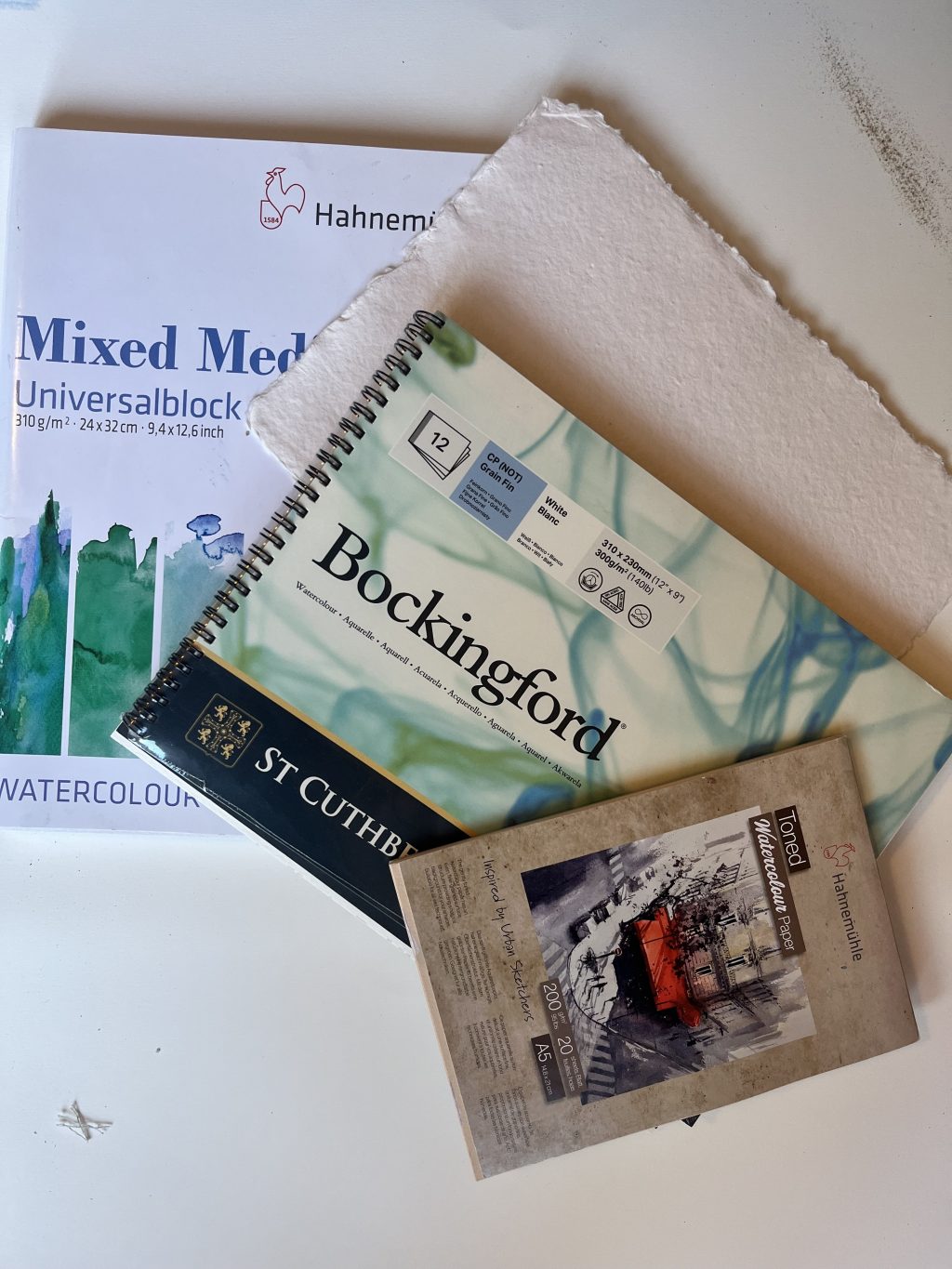 a range of papers suitable for watercolour paint and mixed media