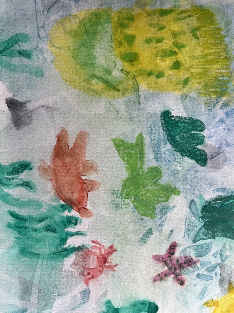 a child's painting of a rock pool using green, yellow and red paint